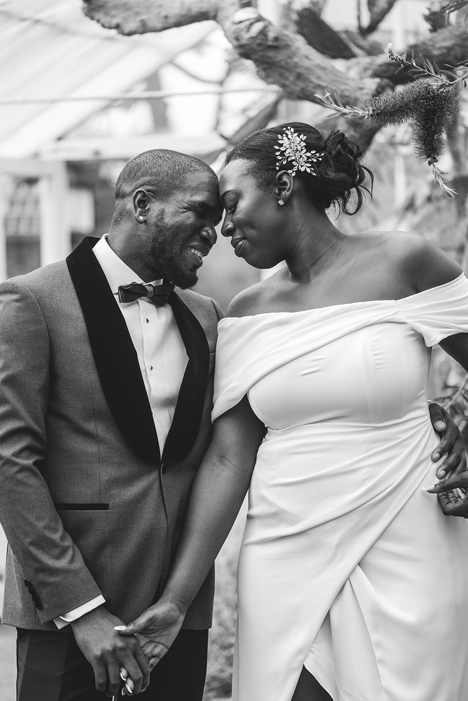 black and white image of newlyweds snuggling at Birmingham Botanical Gardens in the West Midlands by Birmingham wedding photographer byGarazi